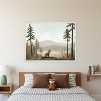 Bedroom with a wooden bed, striped bedding, brown pillows, and a stuffed fox. A large framed illustration of a fox in a misty forest with a lake and mountains hangs centered above the bed. A green lamp sits on a nightstand to the left; books and a wooden tree are on a shelf to the right.
