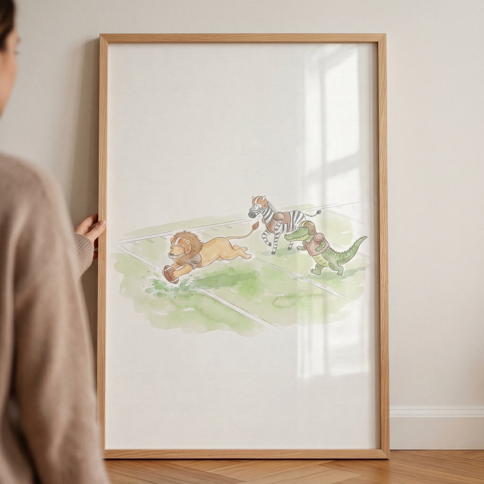 Watercolor yard line football animals wall art showing a lion, zebra, and crocodile on a sports field.