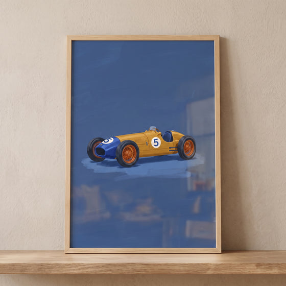 Framed yellow blue vintage car wall art featuring a number five racer on a blue background, displayed on a wooden shelf.