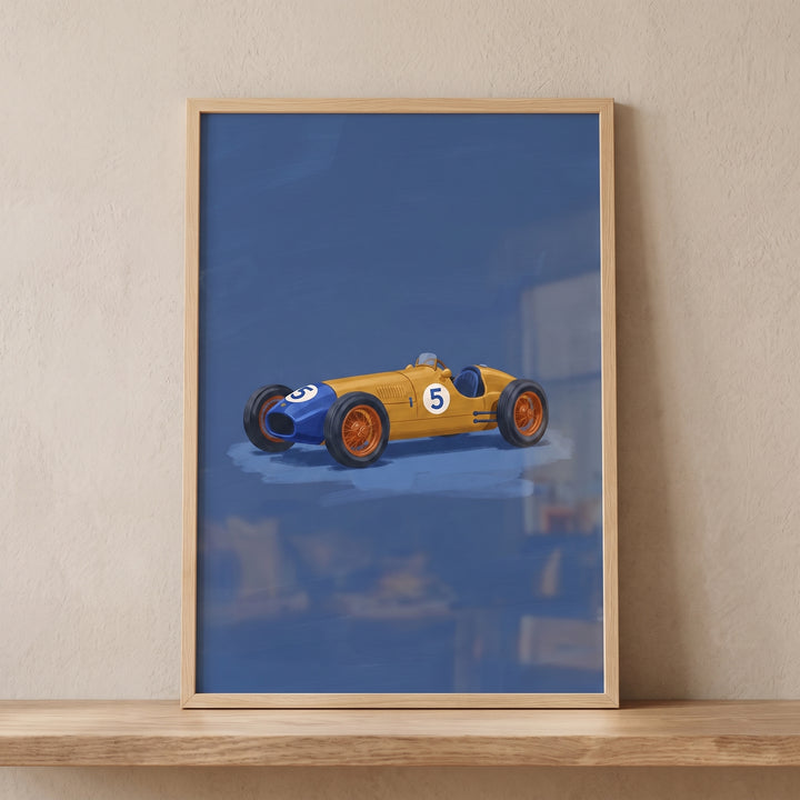 Framed yellow blue vintage car wall art featuring a number five racer on a blue background, displayed on a wooden shelf.